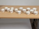 a lot of cups and saucers on the table