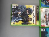 three video games are sitting on a table next to each other