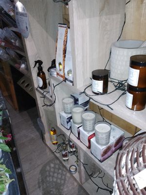 a shelf with candles, candles, and other items on it