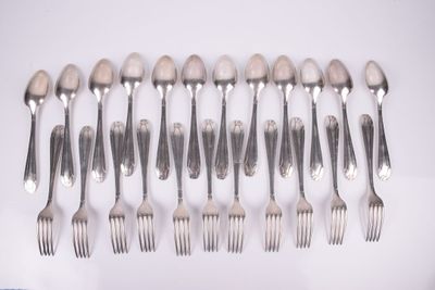 a lot of forks and spoons sitting on a table