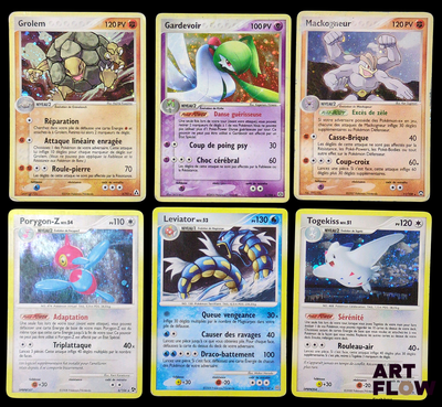 Plusieurs cartes Pokémon sont disposées sur une surface noire