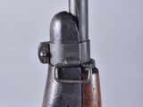 a close up of a gun with a wooden handle