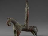 bronze figurine of a horse with a rider on it ' s back