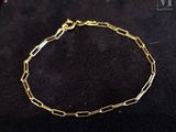 a gold chain bracelet with a link and a clasp