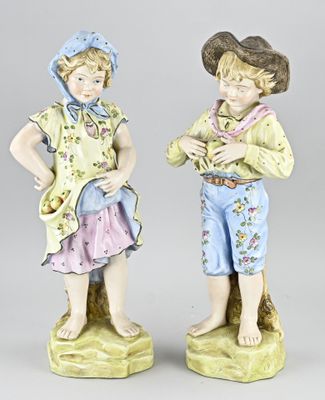 pair of porcelain figurines of a boy and a girl