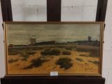 une peinture à l'huile représentant un moulin à vent dans un champ, posée sur une chaise en bois