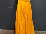 a mannequin mannequin wearing a yellow skirt and white top