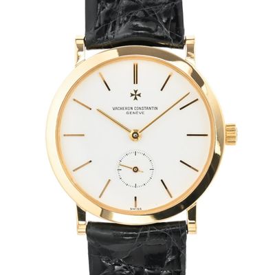 une image représentant une montre en or avec un cadran blanc et un bracelet en cuir noir