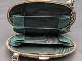 a green purse with a chain hanging from it