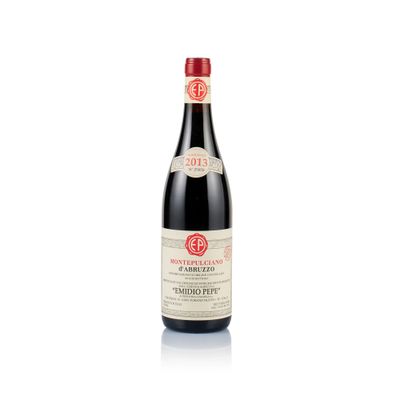 a bottle of red wine sitting on top of a white table