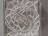 a glass block with a design on it on a table