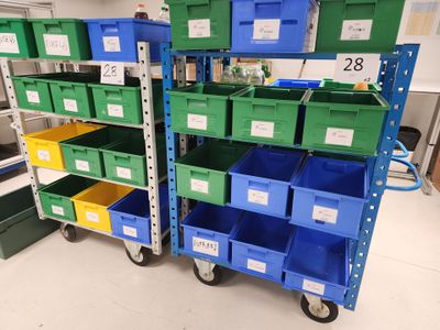 many green and blue bins on the shelves in the room