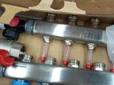 a box that has a bunch of pipes and valves inside of it