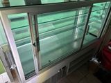 a glass display case in the middle of a room