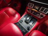 the interior of a car with red leather seats and dashboard controls