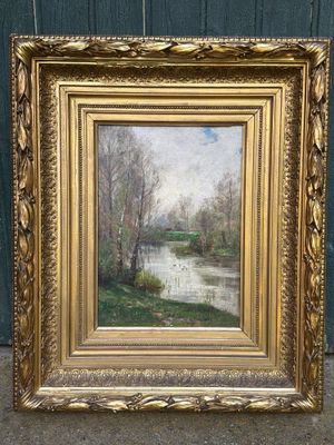 une image représentant un tableau représentant une rivière, dans un cadre doré