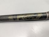 a close up of a pen on a table with a white background