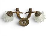 three bronze figurines of angels and flowers on a white background