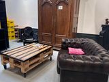 a living room with a couch, chair, coffee table and entertainment center