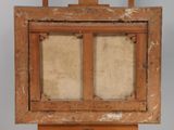 an old wooden easel with a painting on top of it