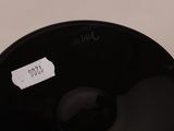 a close up of a black bowl with a sticker on it