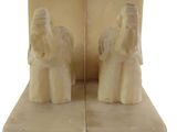 pair of bookends made of white marble with angel figurines on them