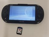 a video game system sitting on a table with a memory card next to it