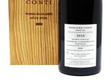 the bottle of wine is next to a wooden box on a white background