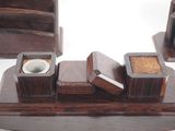 a wooden desk set with a cup and saucer on it