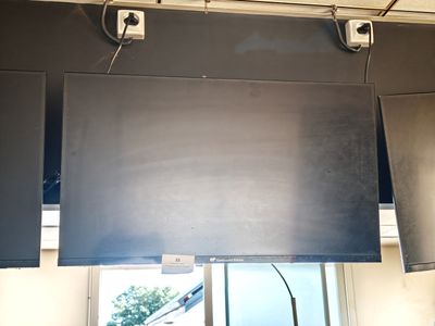 un écran noir suspendu au plafond au-dessus d'une fenêtre