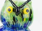 brightly colored glass owl figurine sitting on a white surface