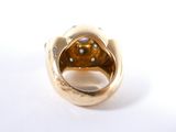 an image of a gold ring with a brown stone in the middle