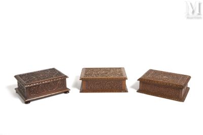 three small wooden boxes sitting next to each other on a white surface