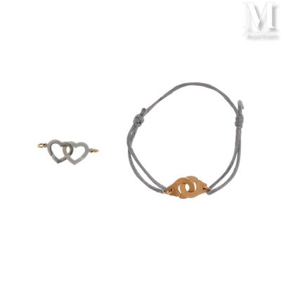 two bracelets with a gold leaf on a gray string