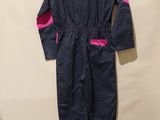 an image of a blue jumpsuit with pink trims hanging on a wall