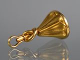 a close up of a gold bell on a reflective surface