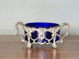 a blue glass bowl sitting on a wooden table