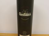 the glenfiddich single malt scotch whisky in a black tin on a wooden table
