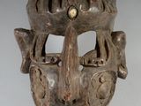 une image représentant un masque en bois sur un fond blanc