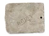 an old brick with the word mud on it and a hole in the middle