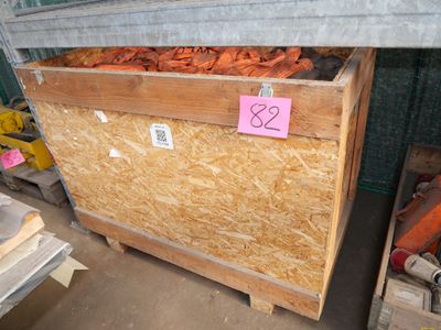 a box of carrots sitting on a pallet in a warehouse