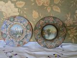 two plates that are sitting on a bed