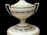 an image of a white and gold vase with a lid