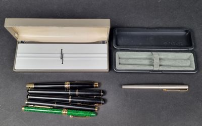an assortment of pens and a case sitting on a table
