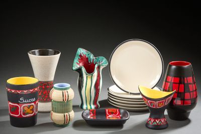 many different types of vases and plates on the table