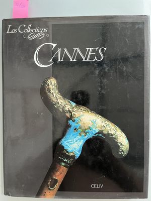 the book is on a table with a hammer on top of it