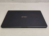 the back of a black laptop computer sitting on top of a white surface
