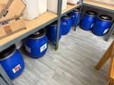 many blue barrels sitting on a shelf in a store