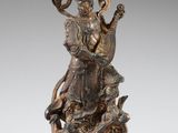 une image représentant une statue en bronze d'un bélier posé sur un rocher