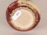 an image of a close up of a vase with a tag on it